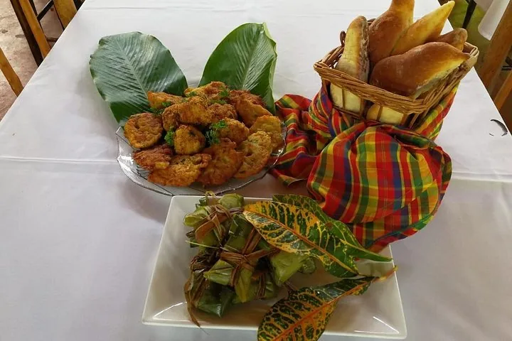 A table spread with various foods including fritters and wrapped parcels